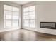 Bright living room with modern fireplace, wood flooring, and lots of natural light at 401 Jersey St, Westfield, IN 46074