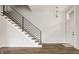 Bright, open-concept living area featuring modern staircase, wood floors, and ample natural light at 401 Jersey St, Westfield, IN 46074