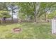 Fenced backyard with green grass and mature trees offering privacy and space at 4050 Westover Dr, Indianapolis, IN 46268