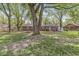 Spacious backyard with mature trees and brick home, offering a serene and private retreat at 4050 Westover Dr, Indianapolis, IN 46268