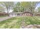 Inviting single-story brick home with attached two-car garage and a lush green lawn at 4050 Westover Dr, Indianapolis, IN 46268