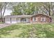 Charming single-story brick home features an attached two car garage and a well-manicured front lawn at 4050 Westover Dr, Indianapolis, IN 46268