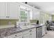 Bright kitchen with white cabinets, stainless steel appliances, and a double sink at 4050 Westover Dr, Indianapolis, IN 46268