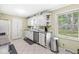 Bright kitchen features white cabinetry, stainless steel appliances, and large windows at 4050 Westover Dr, Indianapolis, IN 46268