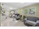 Open-concept living room features a comfortable sitting area and an adjacent kitchen with white cabinetry at 4050 Westover Dr, Indianapolis, IN 46268