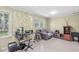 Bright living room features a comfortable seating area, a desk, two windows, and warm natural lighting at 4050 Westover Dr, Indianapolis, IN 46268