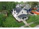 Aerial view of a well-kept home featuring a front porch, garage, and backyard at 410 E North St, Greenfield, IN 46140