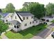 Aerial view of a two-story home with a spacious yard and detached garage at 410 E North St, Greenfield, IN 46140