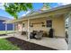 Cozy covered patio with outdoor seating and a grill for summer entertaining at 410 E North St, Greenfield, IN 46140