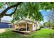 Nice backyard featuring patio, grill, grassy area, and mature trees at 410 E North St, Greenfield, IN 46140