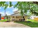Charming home with covered porch, well-maintained lawn, and mature trees at 410 E North St, Greenfield, IN 46140