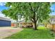 Spacious backyard with lush green lawn and mature shade trees at 410 E North St, Greenfield, IN 46140