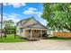 Exterior view of backyard with covered porch and driveway at 410 E North St, Greenfield, IN 46140