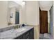 Updated bathroom features a marble countertop, black vanity, modern fixtures, and bright lighting at 410 E North St, Greenfield, IN 46140