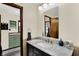 Bathroom with marble countertop, vanity, and modern fixtures, featuring a view into the second bathroom at 410 E North St, Greenfield, IN 46140