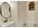 Modern bathroom with stylish black framed oval mirror, white vanity, and neutral wall colors at 410 E North St, Greenfield, IN 46140