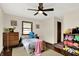 Comfortable bedroom featuring hardwood floors, ceiling fan, natural light, and a cozy atmosphere at 410 E North St, Greenfield, IN 46140