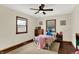 Cozy bedroom is a quiet space for relaxation with a ceiling fan and natural light from two windows at 410 E North St, Greenfield, IN 46140