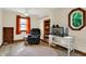 Cozy bedroom with comfortable armchair, built-in shelves, and window at 410 E North St, Greenfield, IN 46140