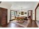 Bright dining room features modern lighting, a table set for six, and beautiful hardwood floors at 410 E North St, Greenfield, IN 46140