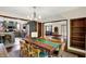 Inviting dining room featuring a modern chandelier, custom table and seating, and views into kitchen at 410 E North St, Greenfield, IN 46140