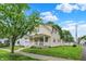 Well-maintained two-story home with a cozy front porch and mature trees at 410 E North St, Greenfield, IN 46140