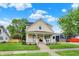 Inviting two-story home featuring a classic front porch and well-maintained lawn at 410 E North St, Greenfield, IN 46140