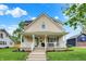 Charming two-story home with a welcoming front porch and landscaped yard at 410 E North St, Greenfield, IN 46140