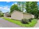 View of the detached garage, with siding and a well-kept lawn in a quiet residential neighborhood at 410 E North St, Greenfield, IN 46140