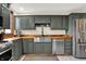 The kitchen features stainless steel appliances and dark green cabinets at 410 E North St, Greenfield, IN 46140