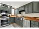 This remodeled kitchen features stainless steel appliances and attractive green cabinets at 410 E North St, Greenfield, IN 46140