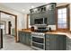 Updated kitchen boasts stainless appliances, stylish cabinets, butcher block counters, and a modern design at 410 E North St, Greenfield, IN 46140