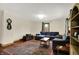 Cozy living room with hardwood floors, a comfortable sectional sofa, and a decorative rug at 410 E North St, Greenfield, IN 46140