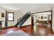 Open-concept living room with beautiful floors, view of staircase, and view into the dining area at 410 E North St, Greenfield, IN 46140