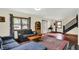 Inviting living room boasts natural light, dark trim windows, and a decorative stairway at 410 E North St, Greenfield, IN 46140
