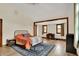 Spacious main bedroom with wood floors, a rug, and a distinct study area with natural light at 410 E North St, Greenfield, IN 46140