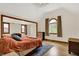 Bright main bedroom with wood floors, a rug, and two windows offering natural light at 410 E North St, Greenfield, IN 46140