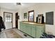 Mudroom with storage cabinets, utility sink, and convenient access to the backyard at 410 E North St, Greenfield, IN 46140