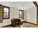 Sunlit home office with wood floors and large windows with wooden trim at 410 E North St, Greenfield, IN 46140