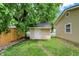 Backyard shed with a single door and siding that matches the detached garage, offering additional storage space at 410 E North St, Greenfield, IN 46140