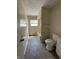 Bathroom with vinyl flooring, a window, toilet, and a bathtub at 4109 East 21St St, Indianapolis, IN 46218