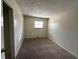 Cozy bedroom features neutral walls and carpet, with a window offering natural light at 4109 East 21St St, Indianapolis, IN 46218