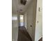 Hallway showcasing doors and carpet, with a view into the bathroom at 4109 East 21St St, Indianapolis, IN 46218