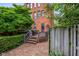 Brick home boasts a cozy deck, perfect for outdoor relaxation and entertaining, surrounded by greenery at 419 N College Ave, Indianapolis, IN 46202