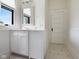 All-white bathroom with vintage-inspired black and white tile flooring at 419 N College Ave, Indianapolis, IN 46202