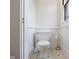 Compact powder room with a white toilet and beadboard walls at 419 N College Ave, Indianapolis, IN 46202