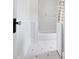 All-white bathroom with vintage-inspired black and white tile flooring at 419 N College Ave, Indianapolis, IN 46202