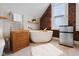 Modern bathroom with a freestanding tub and exposed brick accents at 419 N College Ave, Indianapolis, IN 46202