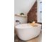Close up view of soaking tub with exposed brick and wooden accents at 419 N College Ave, Indianapolis, IN 46202