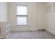 Neutral bedroom with carpeted floor, a window, and a shelving unit at 419 N College Ave, Indianapolis, IN 46202